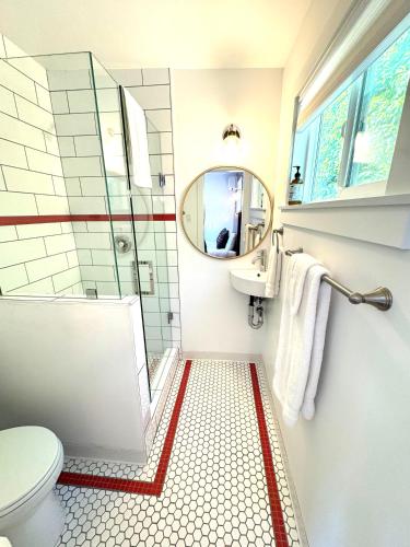 a bathroom with a toilet and a sink and a mirror at Charismatic Downtown Solvang Pet-Friendly Studio in Solvang