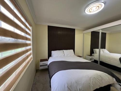 a hotel room with a bed and a mirror at ROBIES MANs CAVE in Alberton