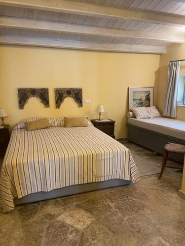 a bedroom with a large bed and a bed at 1867 Manor in Leonidio