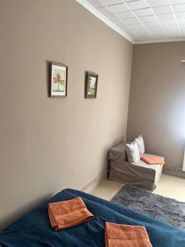 a room with two beds and a couch at Tejfeles vendégház in Porva