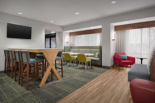 a living room with a table and chairs at Hampton Inn Yorkville in Yorkville