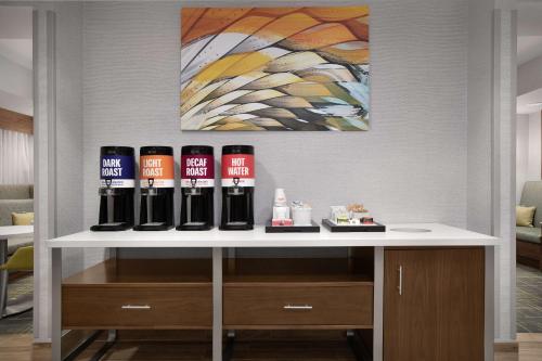 a white table with a bunch of bottles on it at Hampton Inn Yorkville in Yorkville