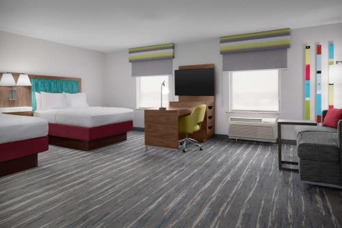 a hotel room with two beds and a desk at Hampton Inn Yorkville in Yorkville