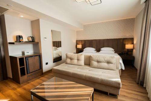 a hotel room with a bed and a couch at Riva Hotel Nişantaşı in Istanbul