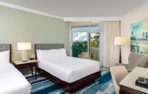 a hotel room with a bed and a living room at Hilton Aruba Caribbean Resort & Casino in Palm-Eagle Beach