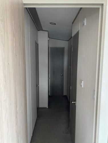 an empty hallway with a door in a building at Vern's Van in Pendine