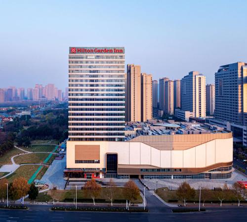 a large building in a city with tall buildings at Hilton Garden Inn Hefei High-Tech Zone in Hefei