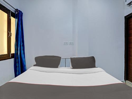 Ένα ή περισσότερα κρεβάτια σε δωμάτιο στο The Pinaki Residency