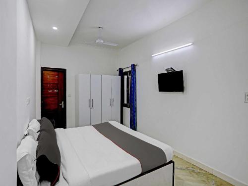 Ένα ή περισσότερα κρεβάτια σε δωμάτιο στο The Pinaki Residency