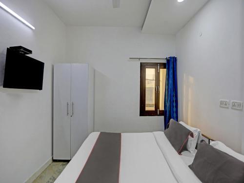 Ένα ή περισσότερα κρεβάτια σε δωμάτιο στο The Pinaki Residency