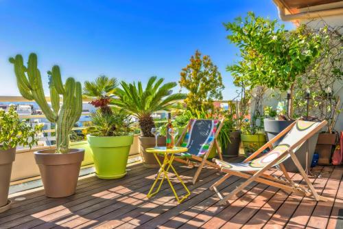 2 chaises et une table sur un balcon avec des plantes dans l'établissement Appartement Prestige, Rooftop & Vue Panoramique, à Marseille