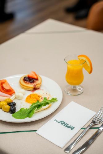 a plate of breakfast food and a glass of orange juice at Riva Hotel Nişantaşı in Istanbul