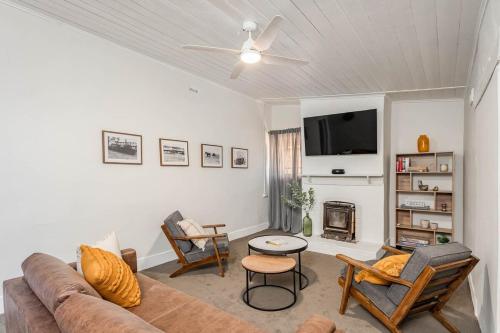 a living room with a couch and a tv at Maranka Homestead in Waikerie