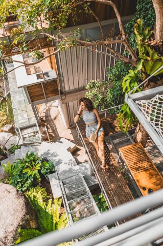 a woman is standing on a metal stairs at Shiva Lodge in Koh Tao