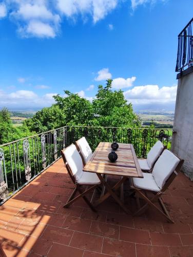 a wooden table and two chairs on a patio at Panoramic Suites - Casa degli Artisti in Citerna