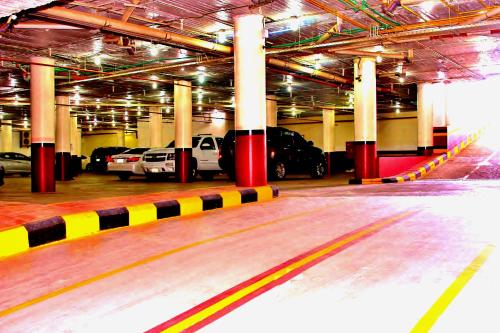 a parking lot with cars parked in a parking garage at Carawan Al Fahad Hotel in Riyadh