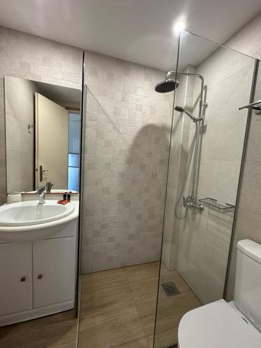 a bathroom with a sink and a shower and a toilet at Electra Studios in Gerani Chanion