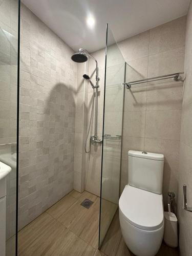 a bathroom with a toilet and a glass shower at Electra Studios in Gerani Chanion