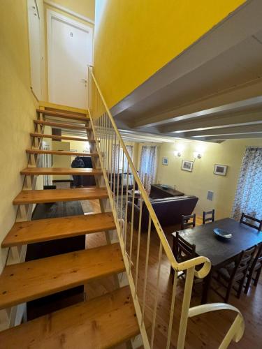a wooden staircase in a room with a table at Agriturismo Vivace in Tolentino