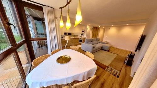 a living room with a white table and chairs at Hadar Deluxe - tucasaenlospirineos in Escarrilla