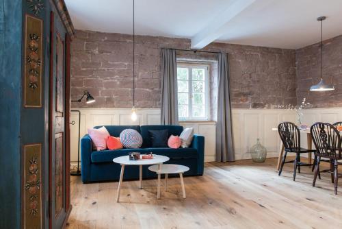 a living room with a blue couch and a table at Palais Wunderlich in Lahr