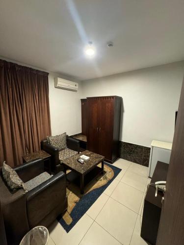 a living room with a couch and a coffee table at Al Thanaa Alraqi Furnished Apartments in Jeddah
