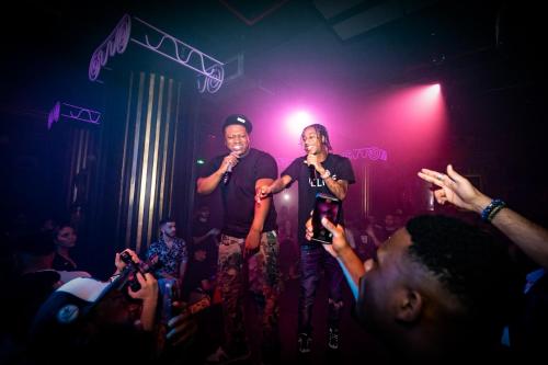 two men standing on a stage singing in front of a crowd at FIVE Jumeirah Village in Dubai