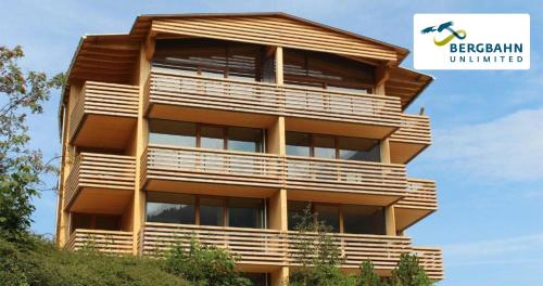 a tall building with balconies on the side of it at Walserkreuz Suiten in Hirschegg