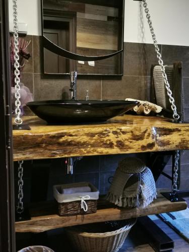 a bathroom with a black sink on a wooden table at Complex Chalet -Turlashkata Kushta in Gabrovo