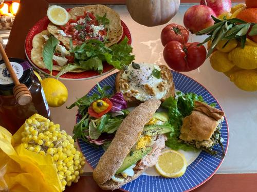 a table with two plates of food and a salad at Stratos ArtDeco House in Kalavasos