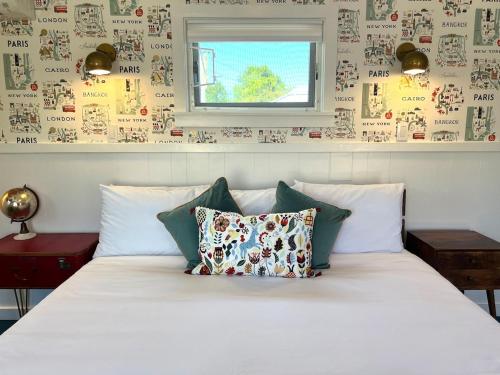 a bed with pillows on it in a bedroom at Urban Luxe Retreat l King Bed l Kitchenette in Solvang