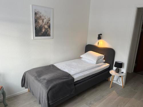 a bed in a room with a picture on the wall at Annexet Kilafors in Kilafors