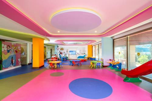 a room with a playroom with tables and chairs at Sun Heaven Queen in Alanya