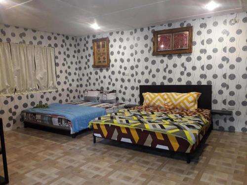 a bedroom with two beds in a room at Ahza syariah in Rantauprapat