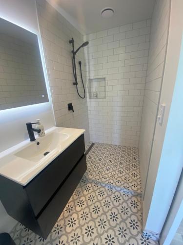 a white bathroom with a sink and a shower at Relaxing Rural Retreat in Huntly