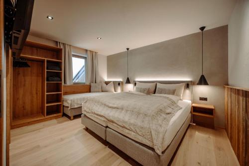 a large bedroom with two beds and a window at Ferienanlage Central in Flachau
