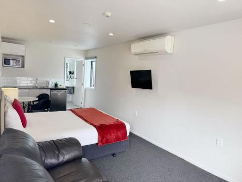 a hotel room with a bed and a couch at Abbey Motor Lodge in Christchurch