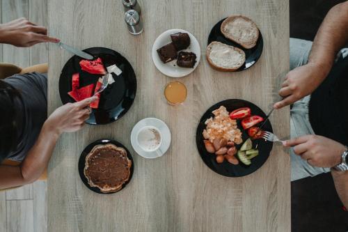 a group of people sitting around a table with food at ADEO HOTEL Sport & SPA in Ruse