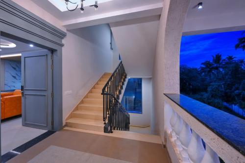 a staircase in a house with a view of the ocean at Vega Suites with Private Indoor Pool in Colva