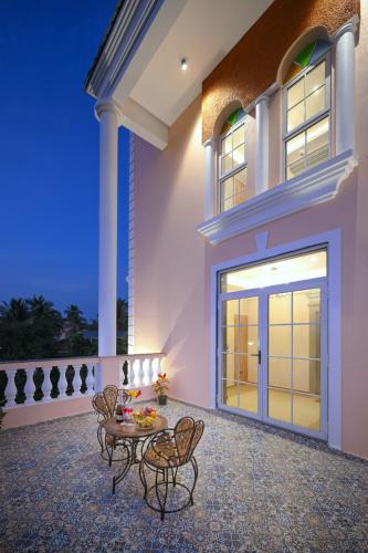 a patio of a house with a table and chairs at Vega Suites with Private Indoor Pool in Colva