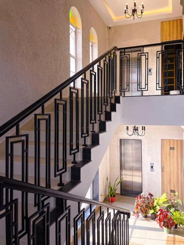 a staircase in a house with black railings at Vega Suites with Private Indoor Pool in Colva