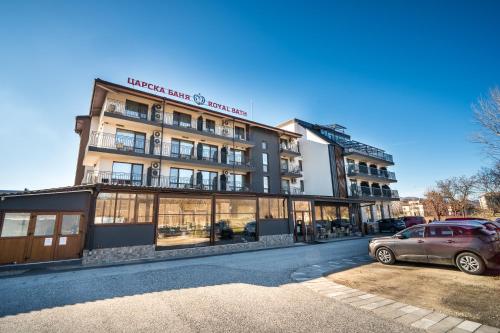 a building with a car parked in front of it at Hotel Royal Bath in Banya