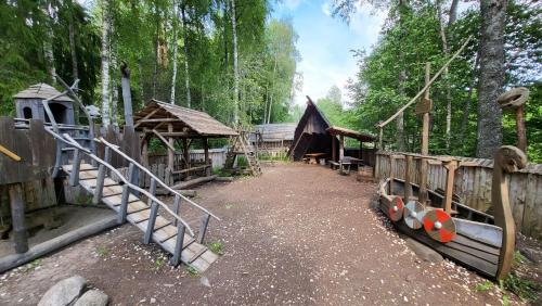 a playground in a forest with wooden structures at Viikingite küla in Saula