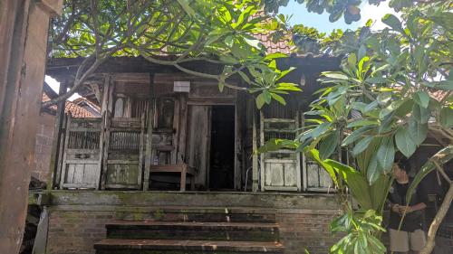 a person standing in front of a building at Cafe de Paris Homestay in Girijati