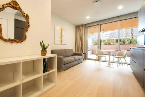 a living room with a couch and a table at Genoa Downtown East Water Front in Genova