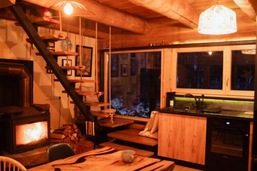 a living room with a fireplace and a stove at River House in Nītaure