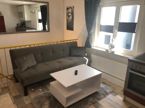 a living room with a couch and a table at Müritz Apartments in Waren