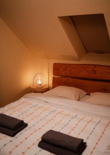 a bedroom with a bed with two towels on it at River House in Nītaure