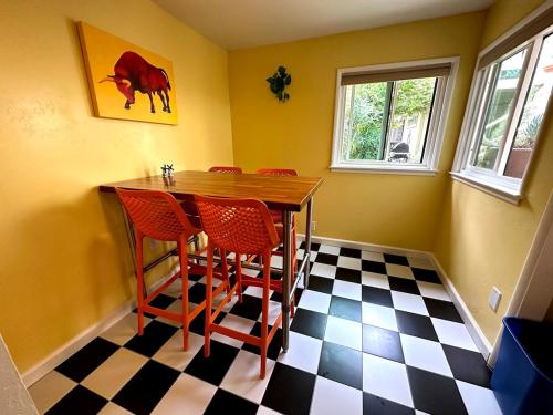 a dining room with a table and chairs on a checkered floor at Couples Cottage l Steps to Downtown in Solvang