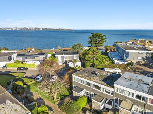 an aerial view of a house and the ocean at Heathcliff, Coastal Walks and Sea Views in Brixham